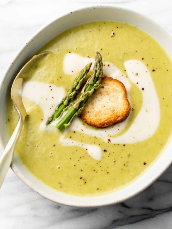 a bowl of asparagus soup with a spoon