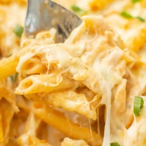 closeup of a serving spoon with a portion of buffalo chicken casserole