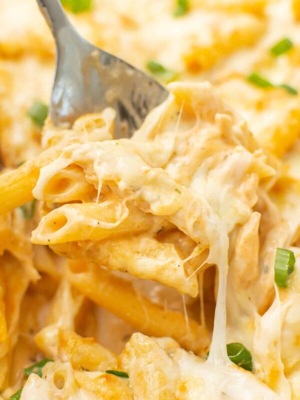 closeup of a serving spoon with a portion of buffalo chicken casserole