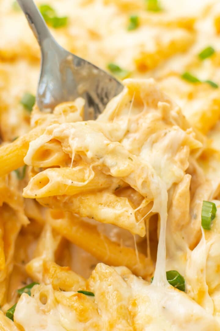 closeup of a serving spoon with a portion of buffalo chicken casserole