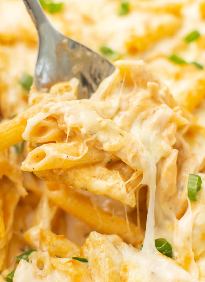 closeup of a serving spoon with a portion of buffalo chicken casserole