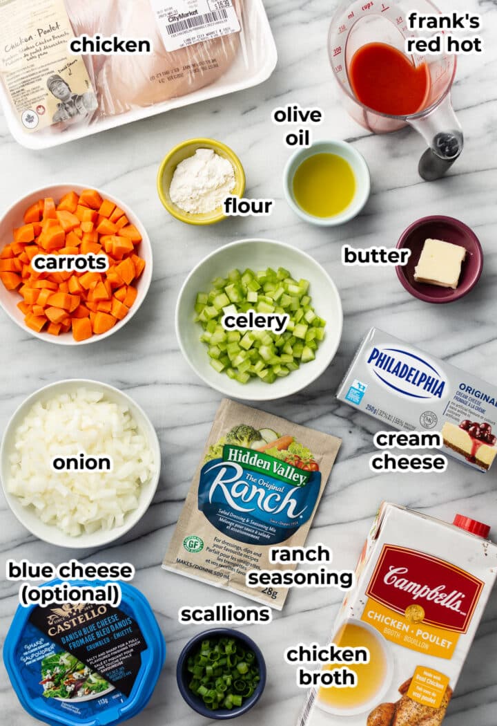 ingredients for buffalo chicken soup in prep bowls on a counter