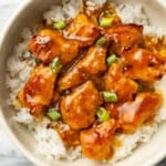 homemade orange chicken over rice in a bowl