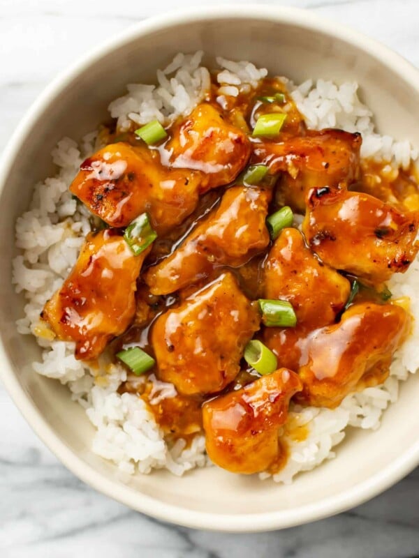 homemade orange chicken over rice in a bowl