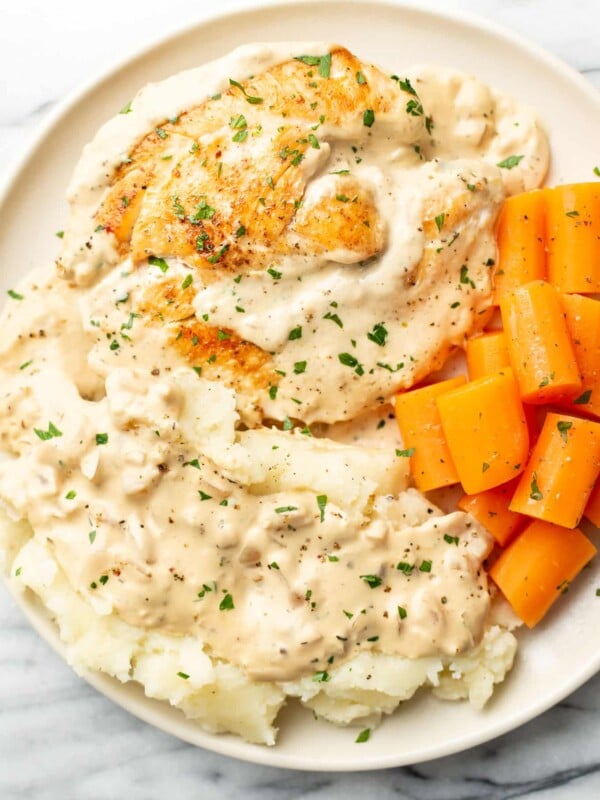 a plate with cream cheese chicken, carrots, and mashed potatoes