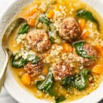 a bowl of italian wedding soup with a spoon