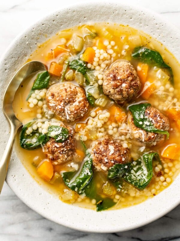 a bowl of italian wedding soup with a spoon