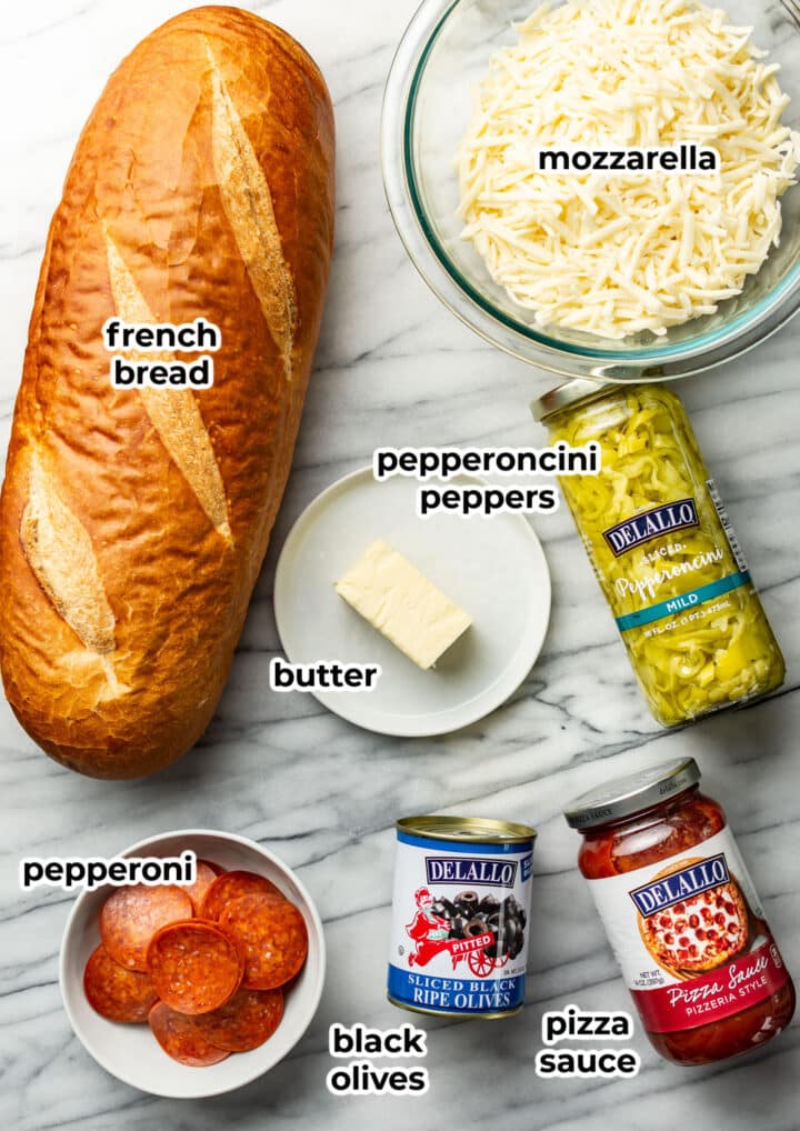 ingredients for french bread pizza in prep bowls and jars