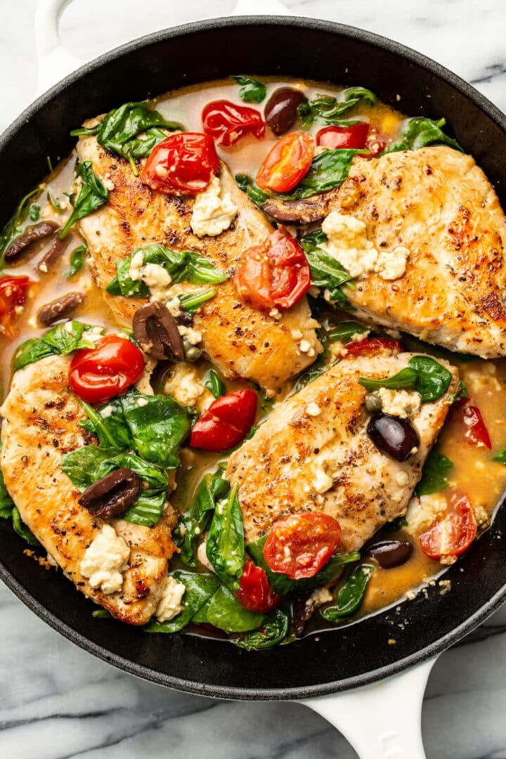 a skillet with mediterranean chicken