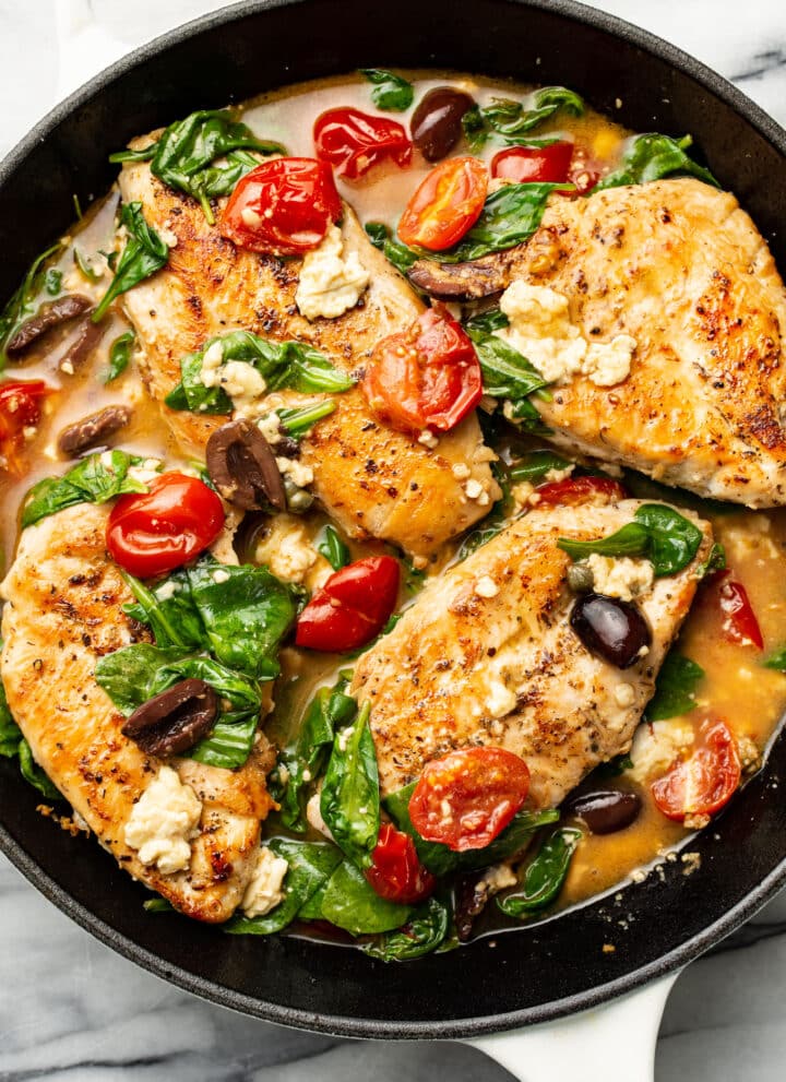a skillet with mediterranean chicken