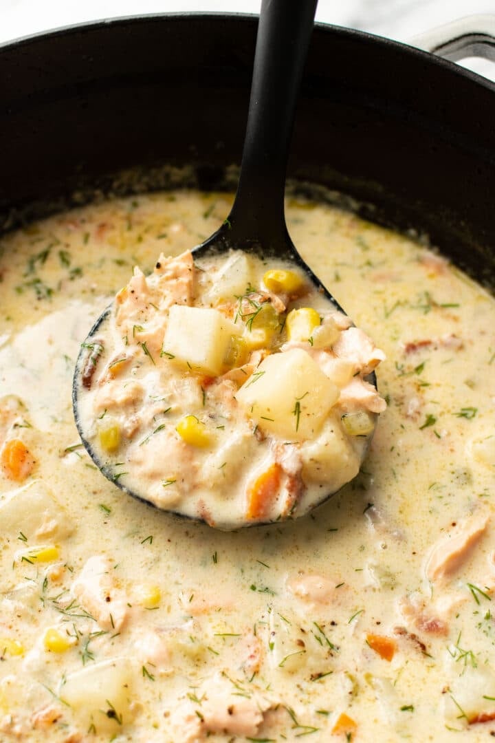 a ladle with salmon chowder