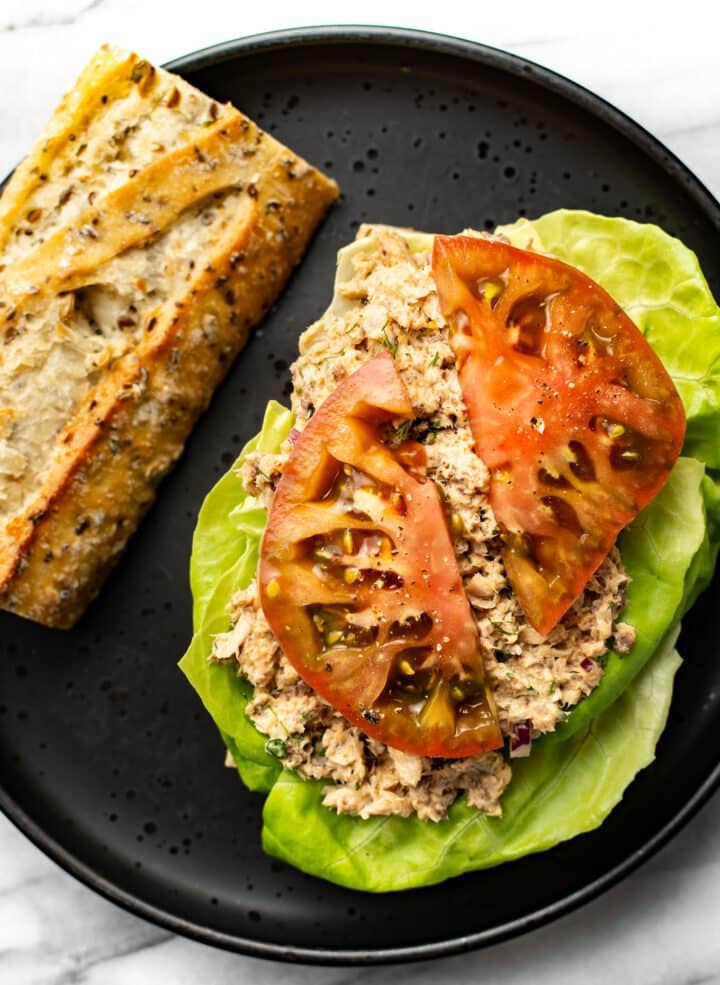 a plate with a sardine salad sandwich