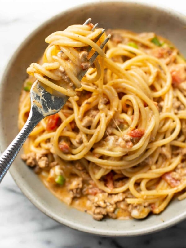 a bowl with taco spaghetti and a fork