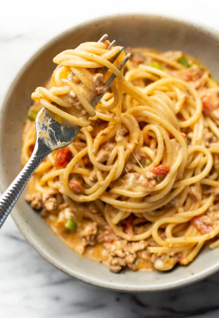 a bowl with taco spaghetti and a fork