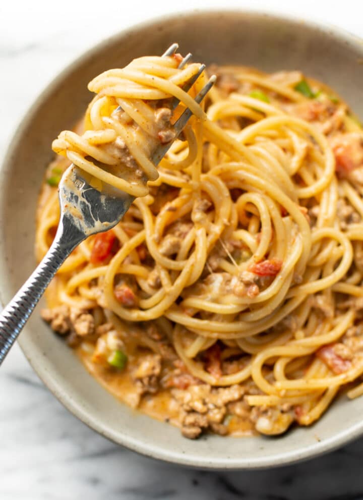 a bowl with taco spaghetti and a fork