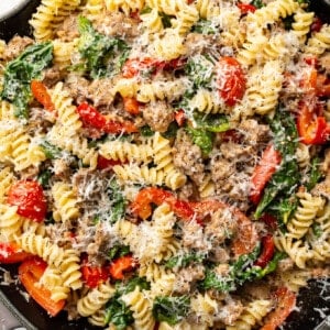 a skillet with sausage and vegetable pasta