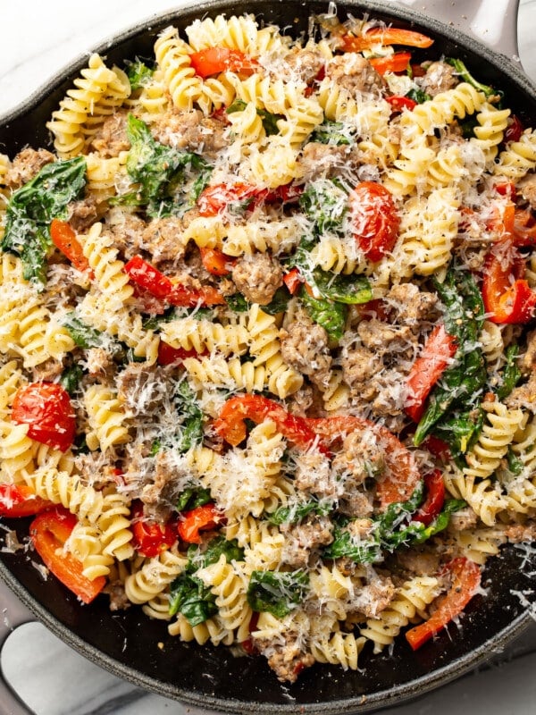 a skillet with sausage and vegetable pasta