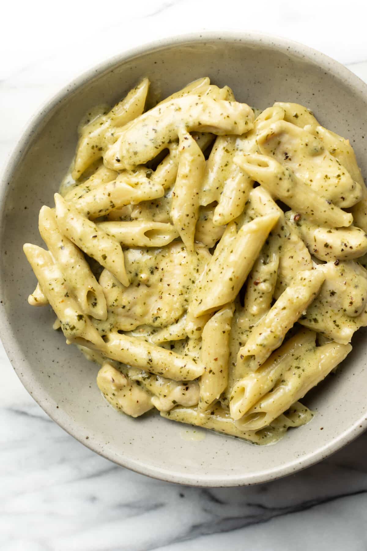 a bowl of creamy chicken pesto pasta