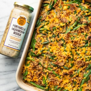 a baking tray with green bean casserole next to a jar of soup