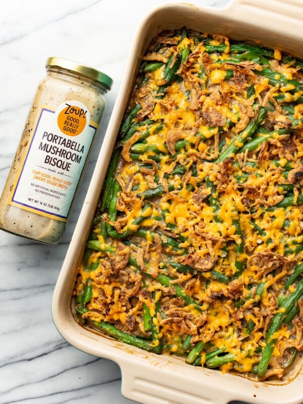 a baking tray with green bean casserole next to a jar of soup