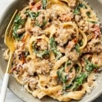 a bowl of Tuscan sausage pasta with a fork