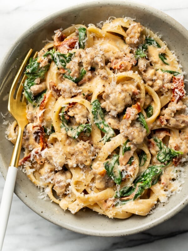 a bowl of Tuscan sausage pasta with a fork