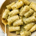 a bowl of pesto pasta with a fork