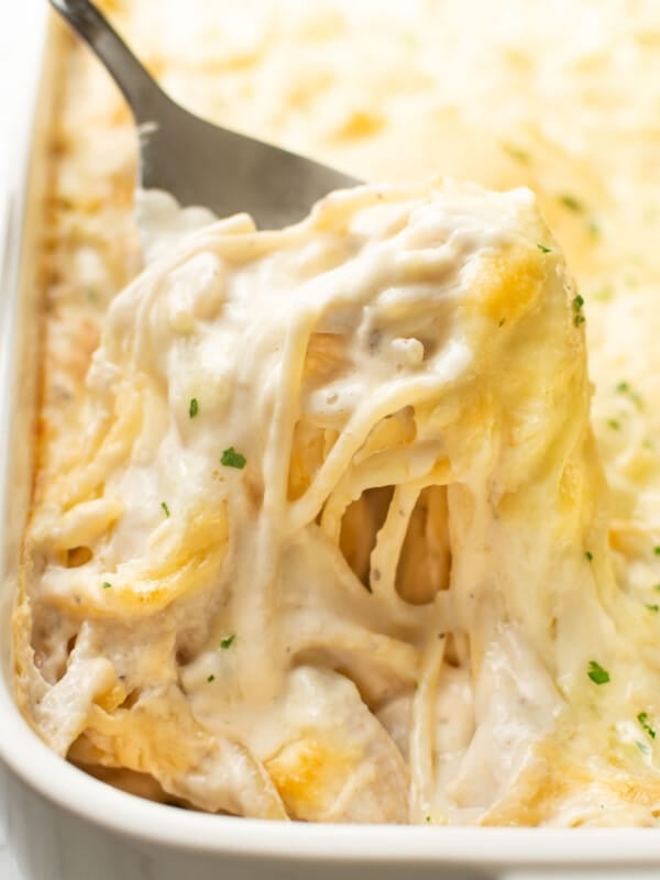 closeup of a baking dish with turkey tetrazzini and a serving spoon