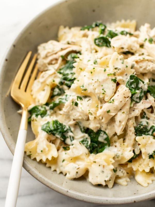 a bowl of boursin chicken pasta with a fork