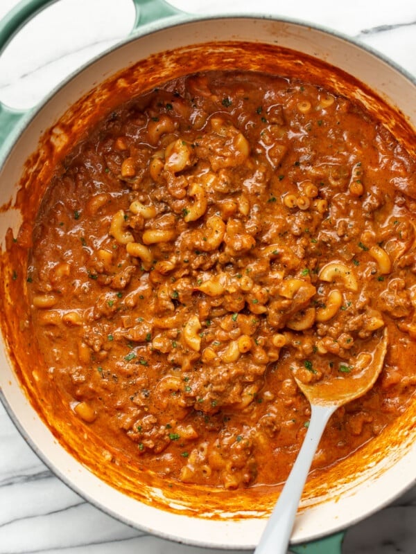 a large pot with chili mac and a serving spoon