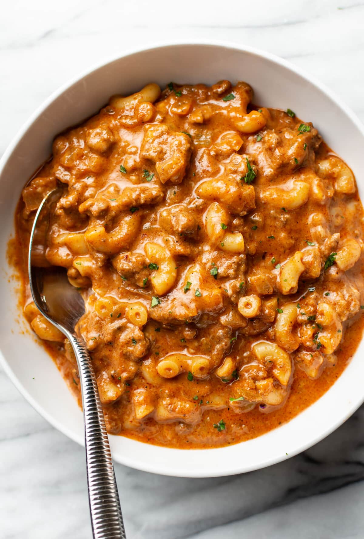 a bowl of chili mac with a spoon