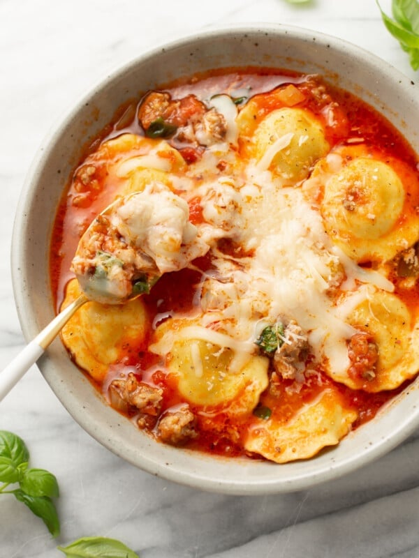 a bowl of ravioli soup with a spoon