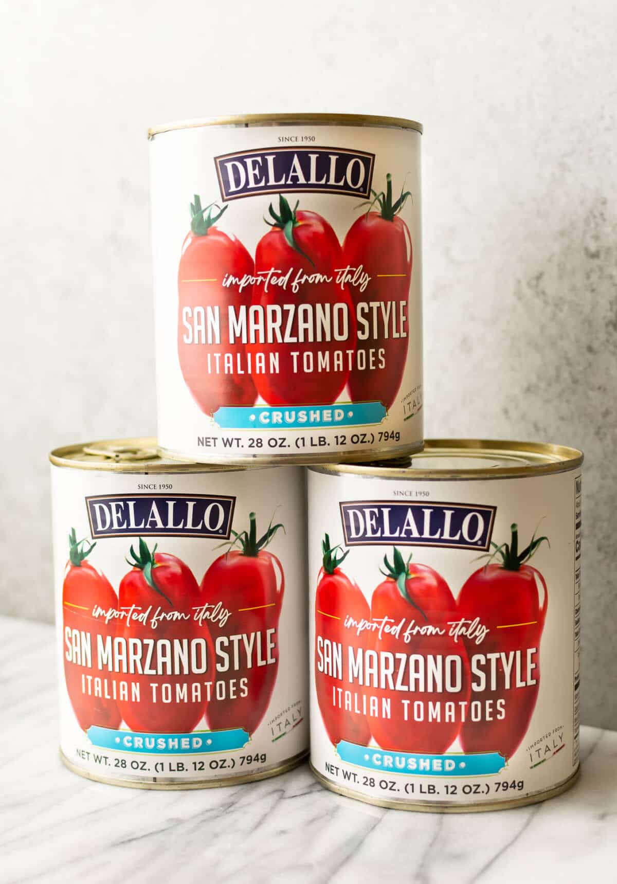 three cans of san marzano crushed tomatoes