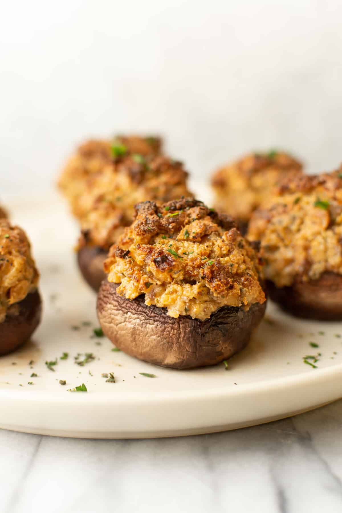 a plate with several italian sausage stuffed mushrooms