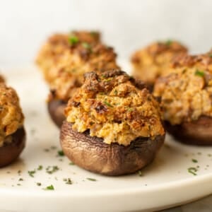 a plate with several italian sausage stuffed mushrooms