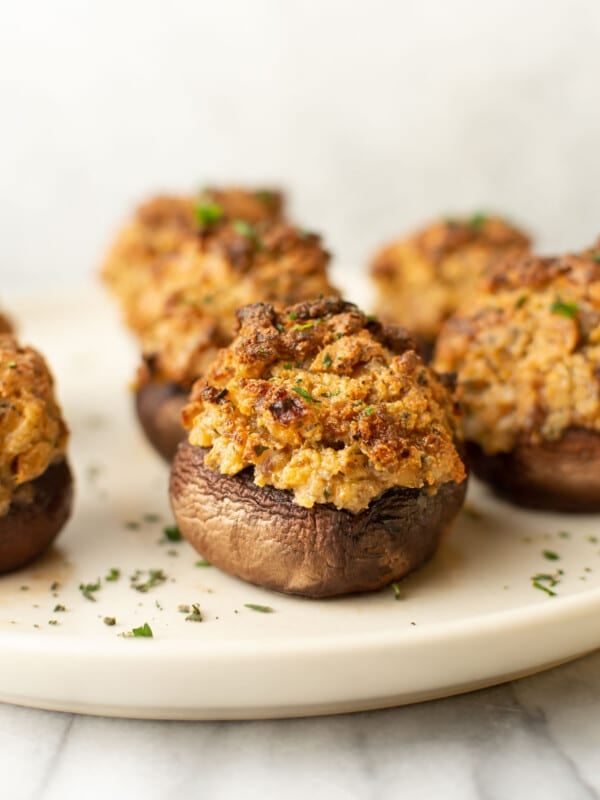 a plate with several italian sausage stuffed mushrooms