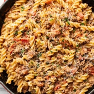 a skillet with creamy ground beef pasta and parmesan