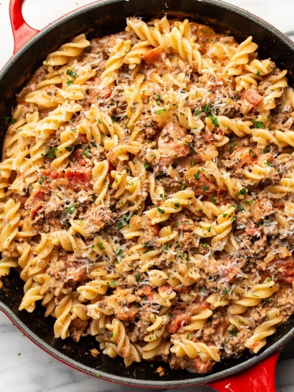 a skillet with creamy ground beef pasta and parmesan