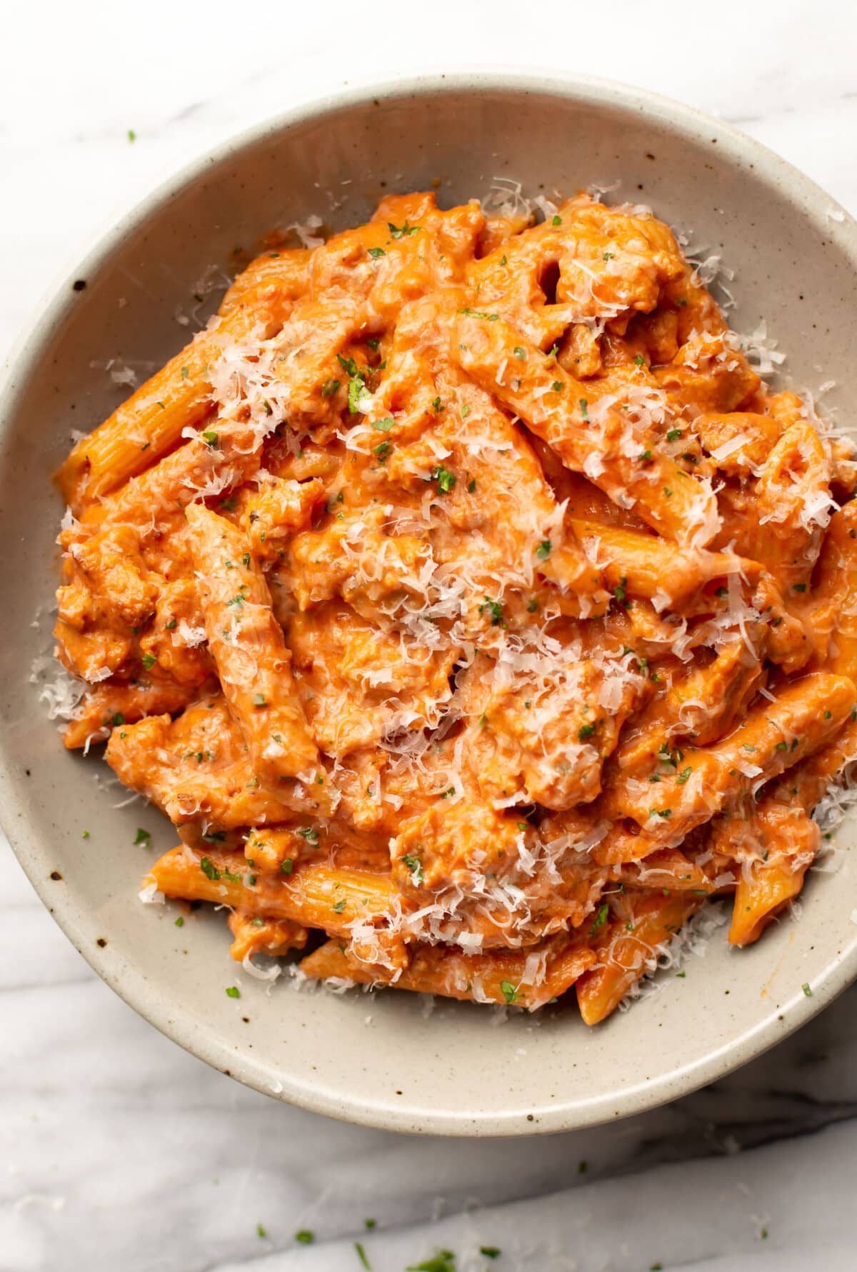 a bowl of italian sausage tomato pasta with parmesan