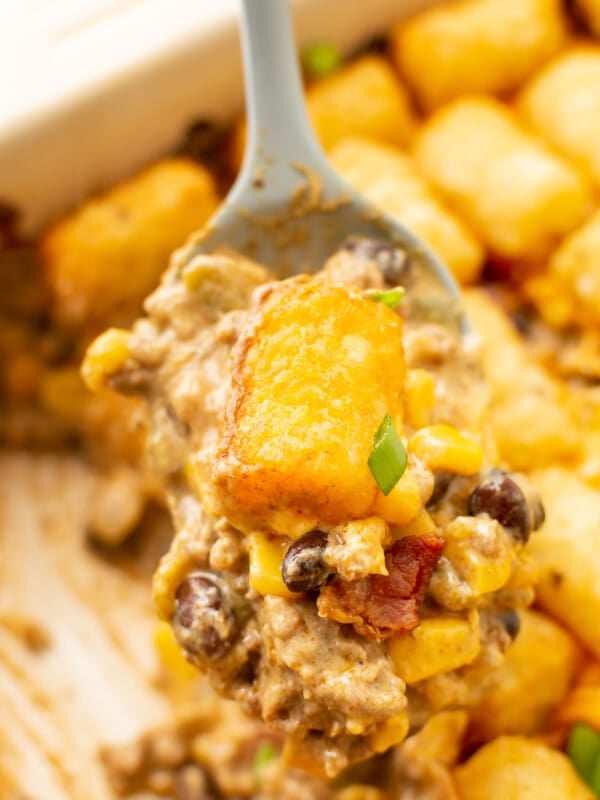 closeup of a spoonful of cowboy casserole over a baking dish