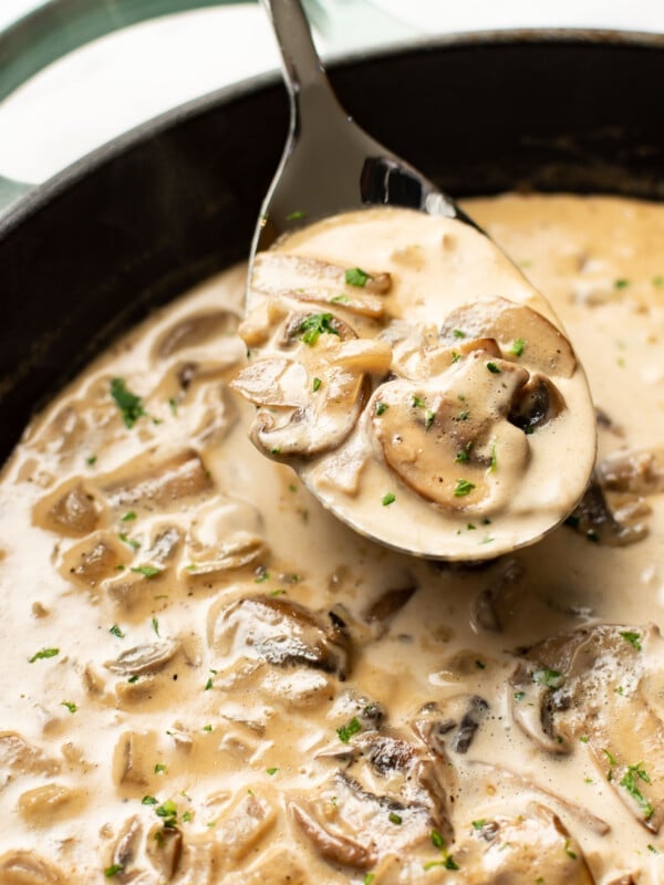 a skillet with marsala sauce and a serving spoon