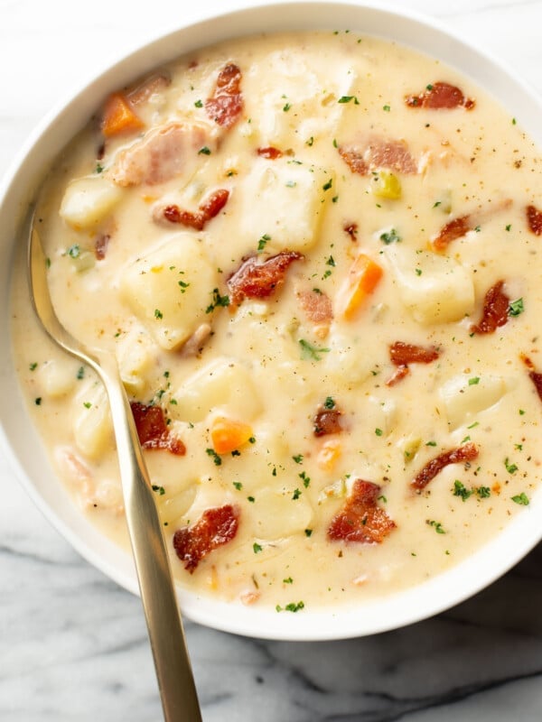 a bowl of bacon potato soup with a spoon