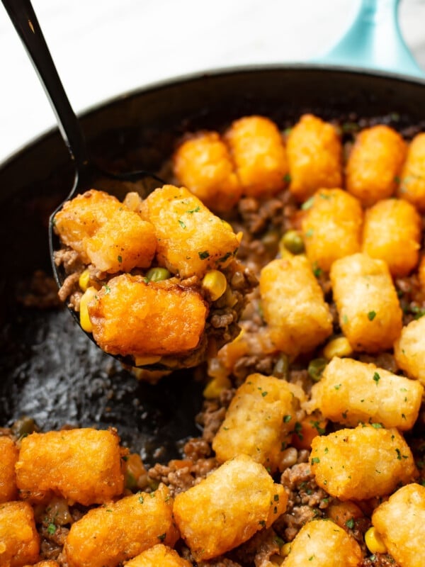 a skillet with tater tot shepherd's pie and a serving spoon