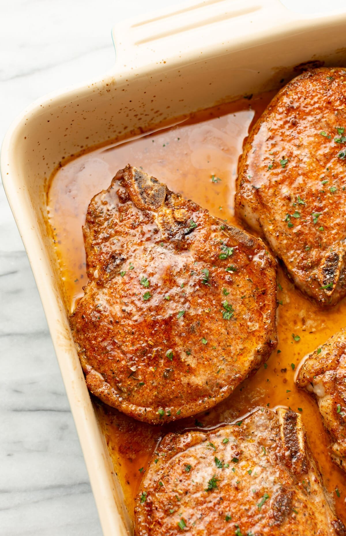 closeup of a casserole dish with baked pork chops