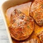 closeup of a casserole dish with baked pork chops