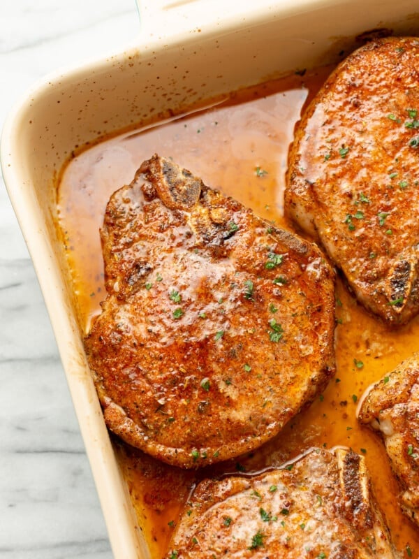 closeup of a casserole dish with baked pork chops