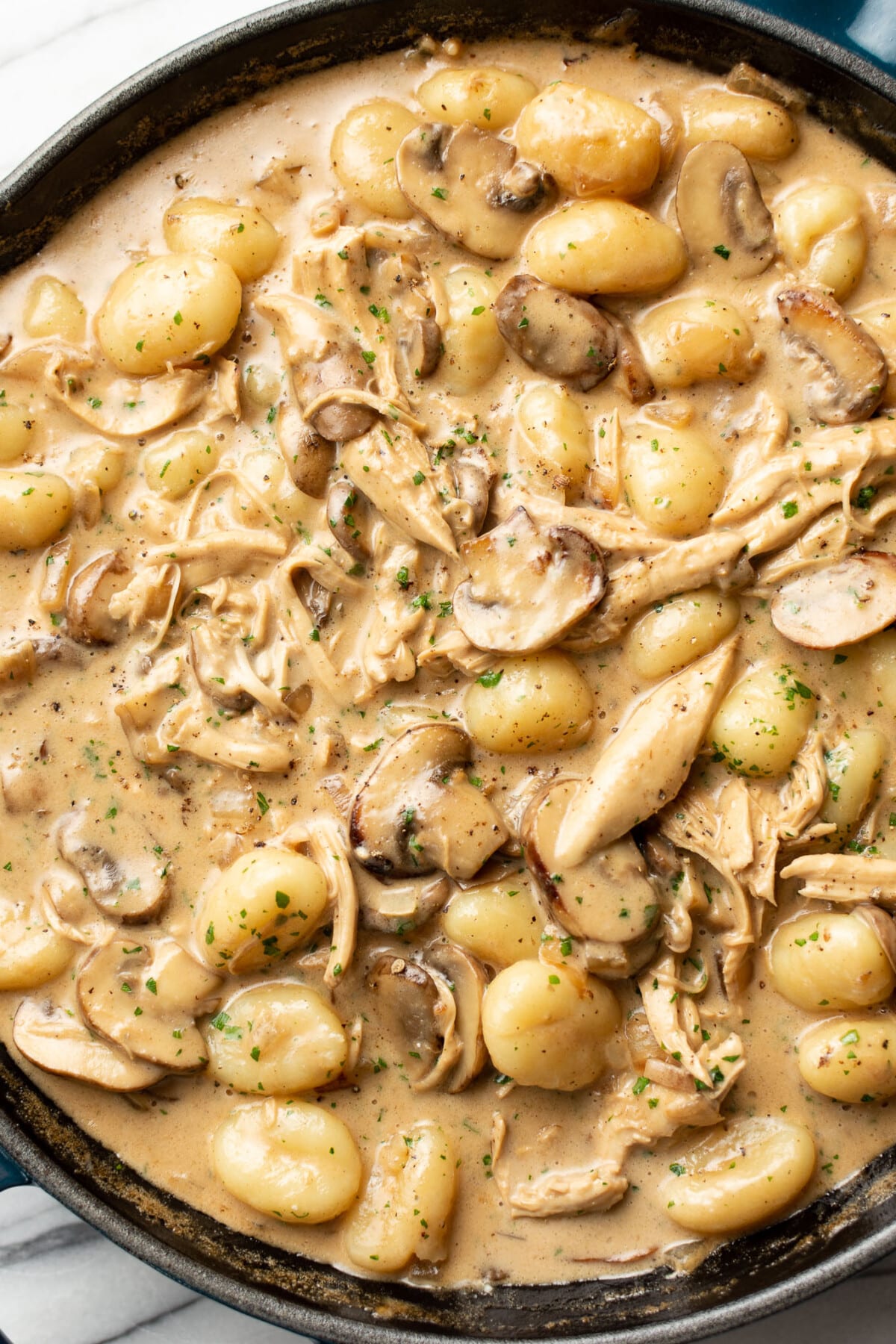 a skillet with chicken marsala gnocchi