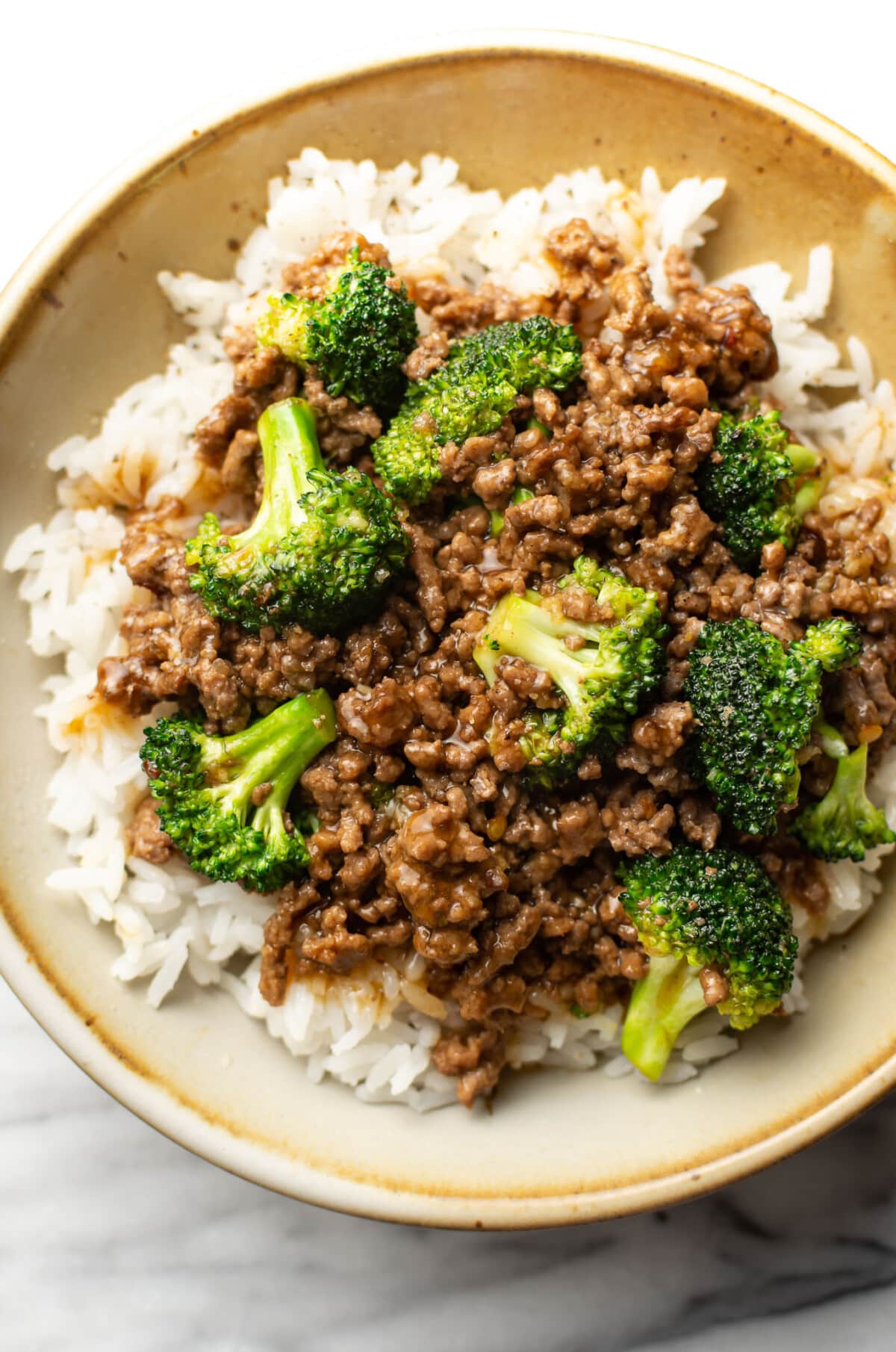 a bowl with ground beef and broccoli over rice