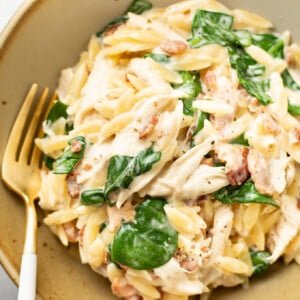 a bowl of chicken bacon ranch orzo with a fork