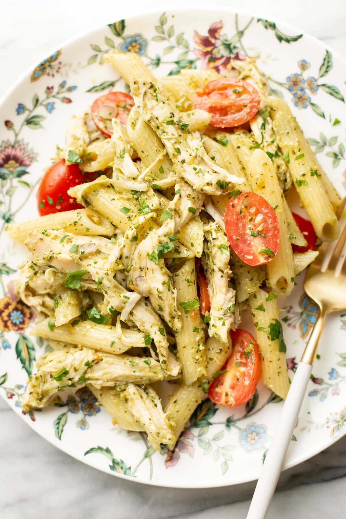 a plate with chicken pesto pasta salad and a fork
